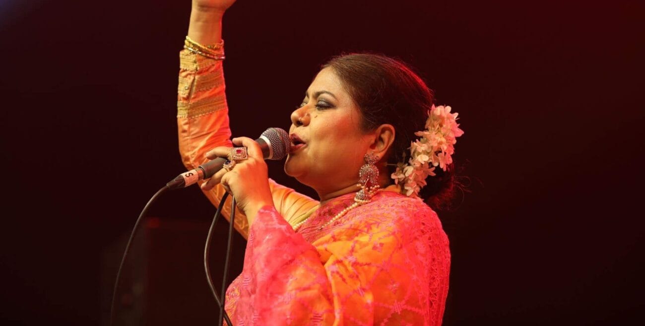 Kanak Chapa performing on stage in red saree